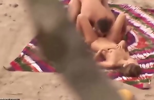 Horny couple is having steamy sex on the beach, in